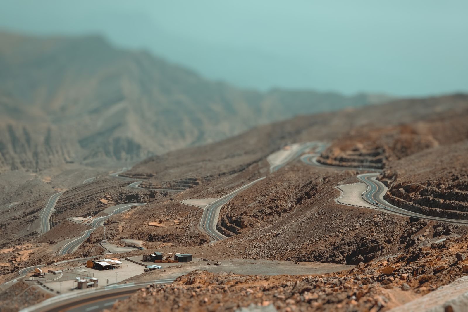 Aerial view of switchback roads cut into the rocky Jebel Jais mountains in Ras Al Khaimah.